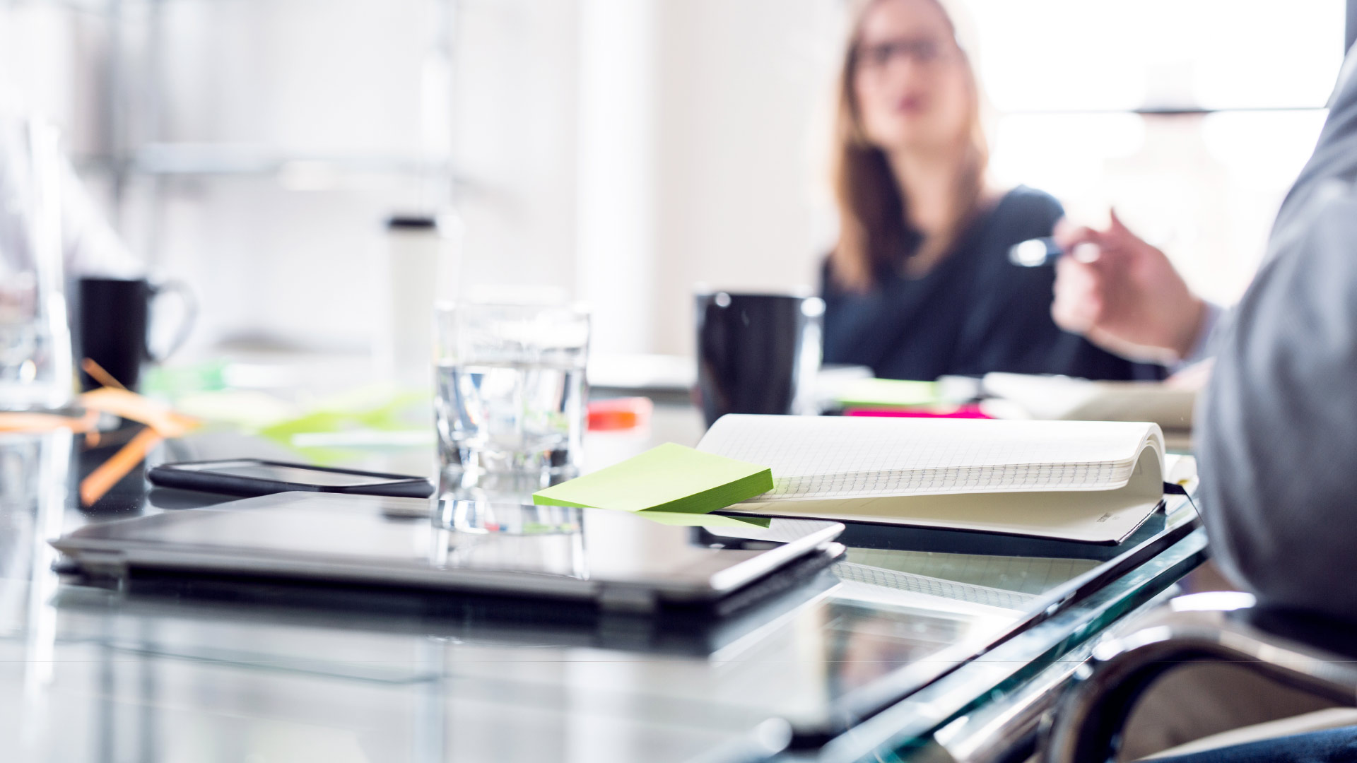 Business meeting with notepad and digital devices