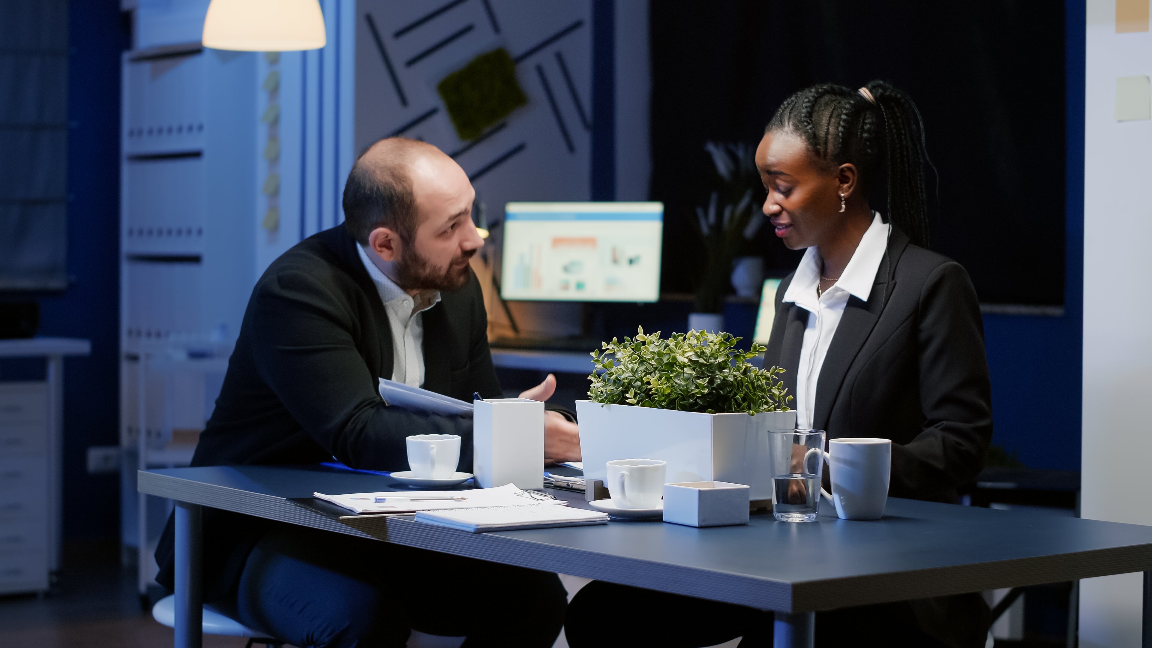 business-professionals-talking-in-office-at-night-2026-03-19-02-10-35-utc