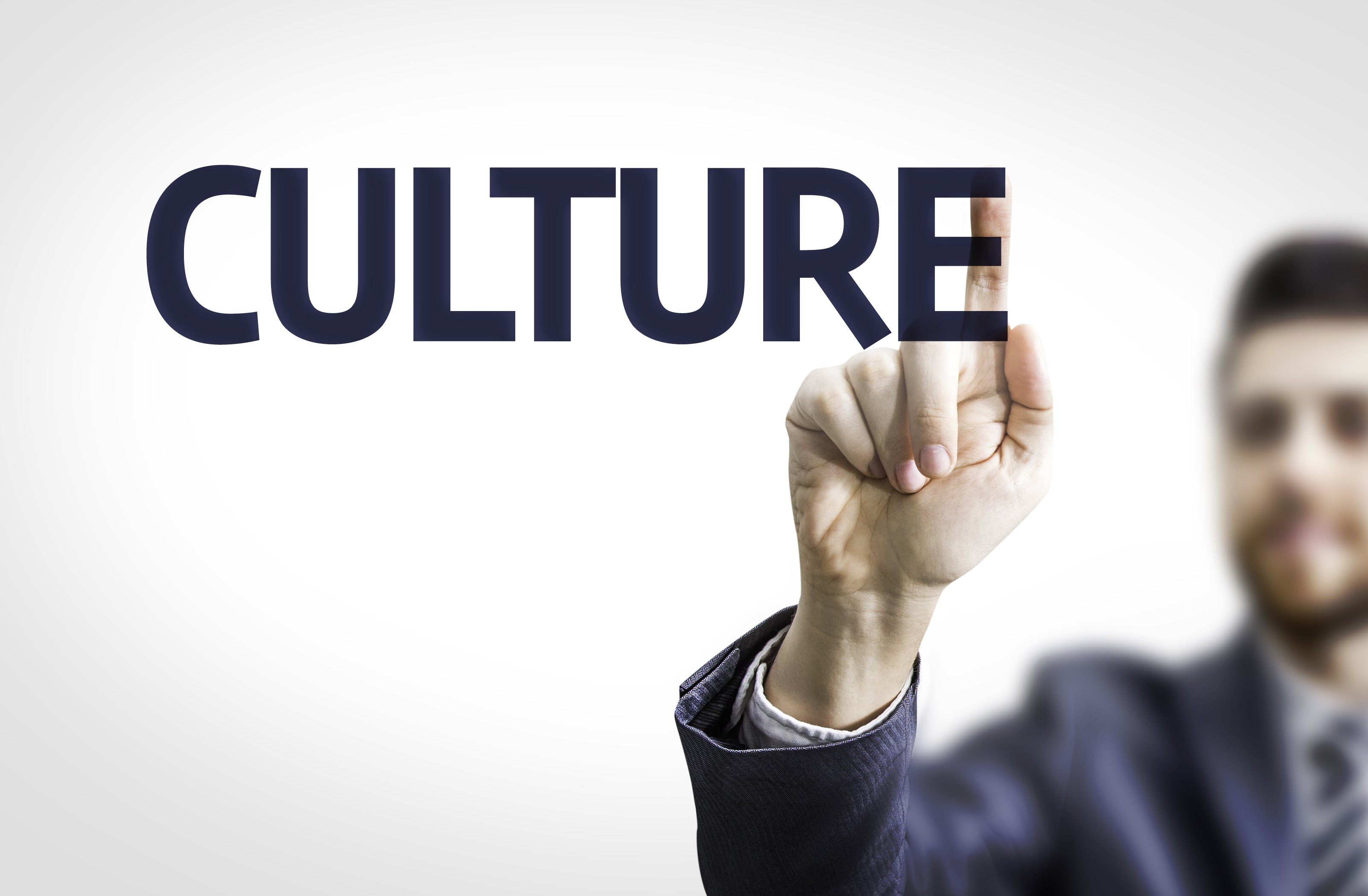 banner with the word culture being focused by a hand of an office man